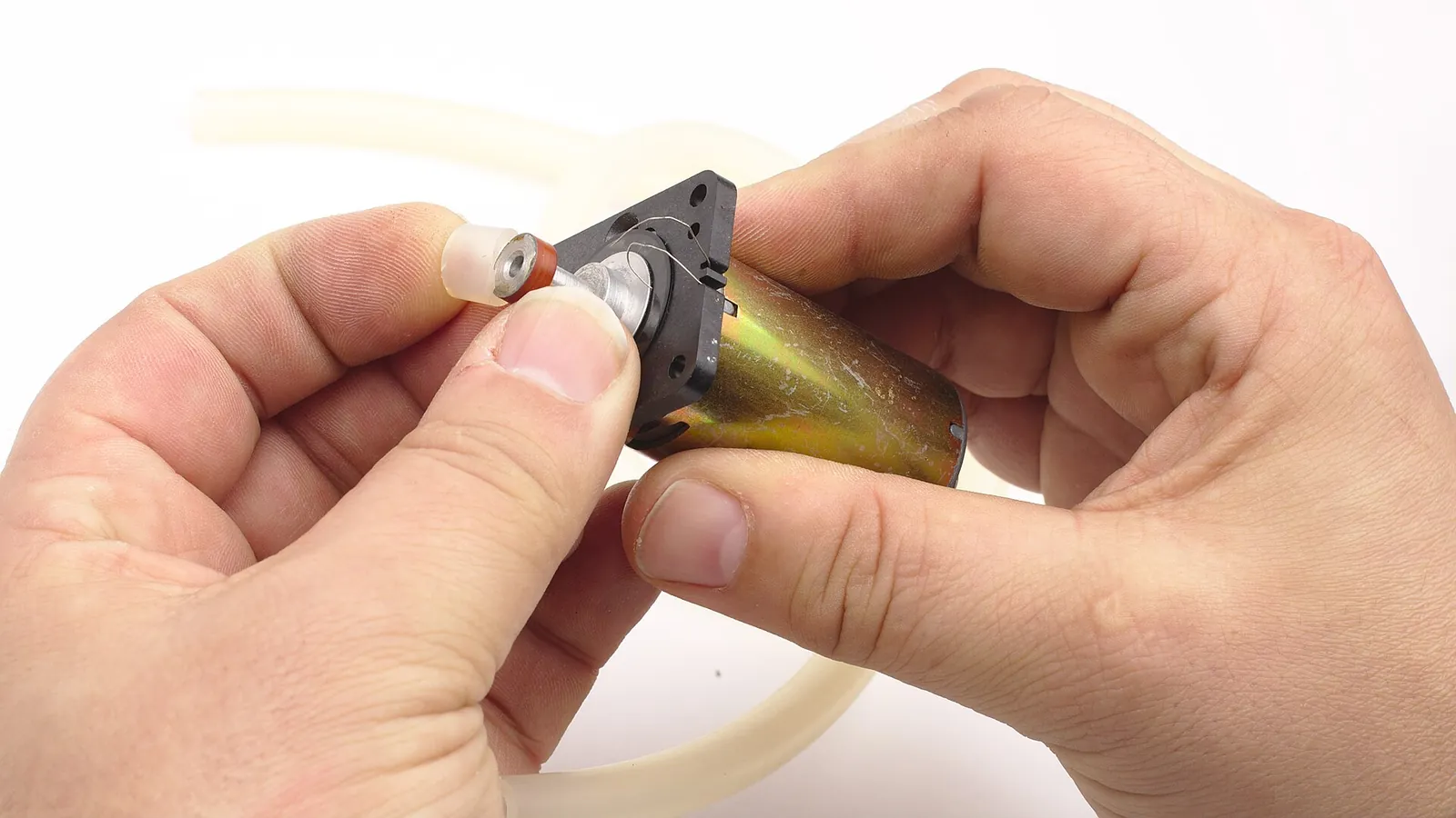 Hands fitting tubing onto a peristaltic pump drive wheel