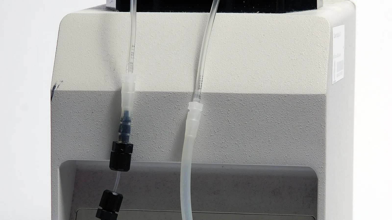 Laboratory peristaltic pump with tubing set up on a bench