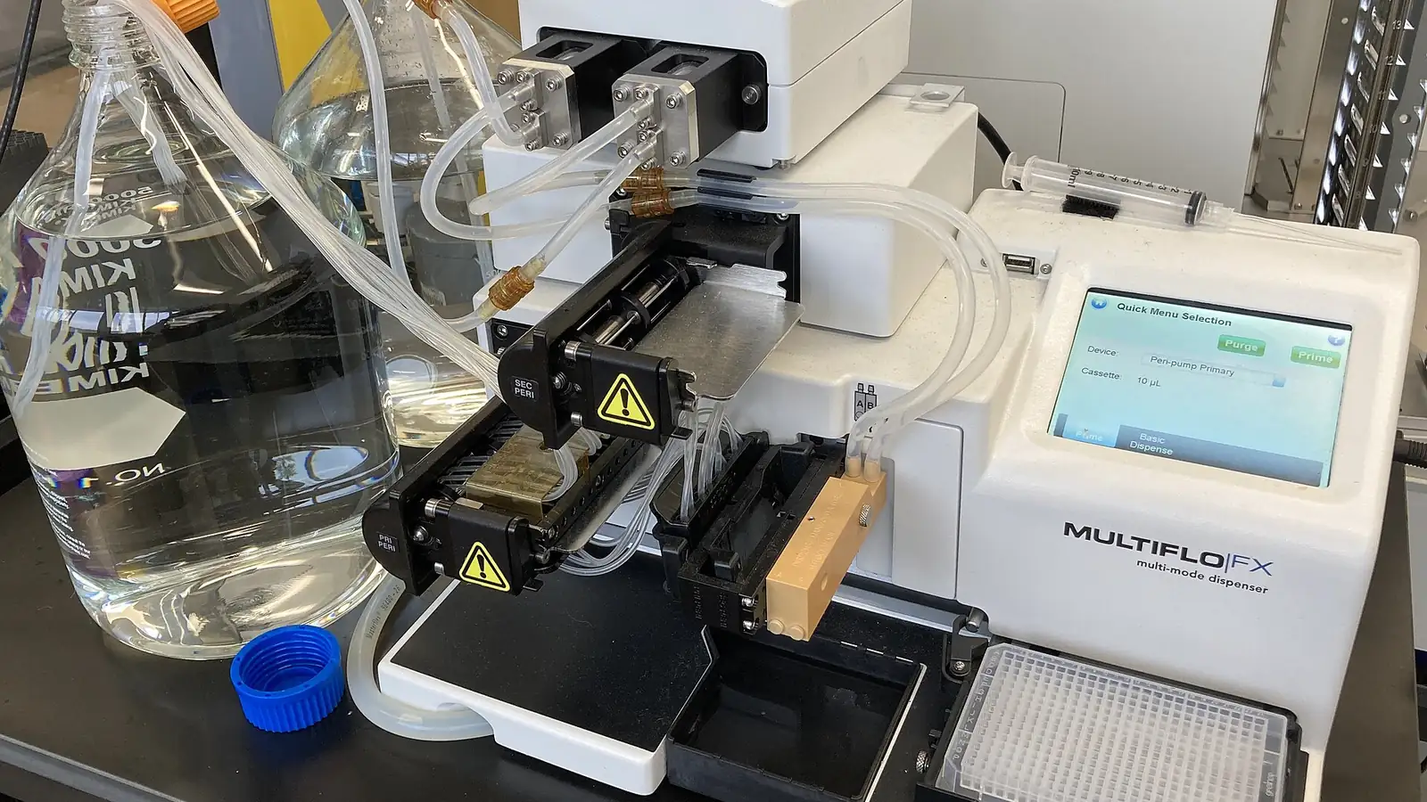 Laboratory reagent dispenser with tubing, flasks and a touchscreen