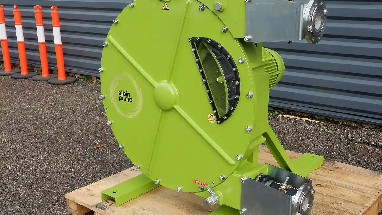Heavy-duty hose pump set up outdoors on a worksite pallet