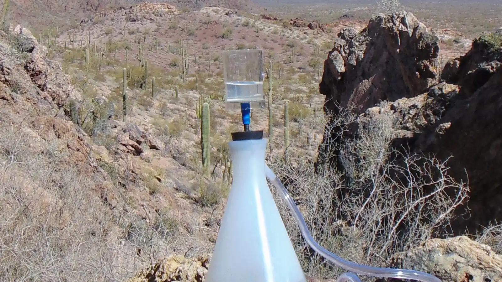 Manual pump rig moving water through a filter in the field