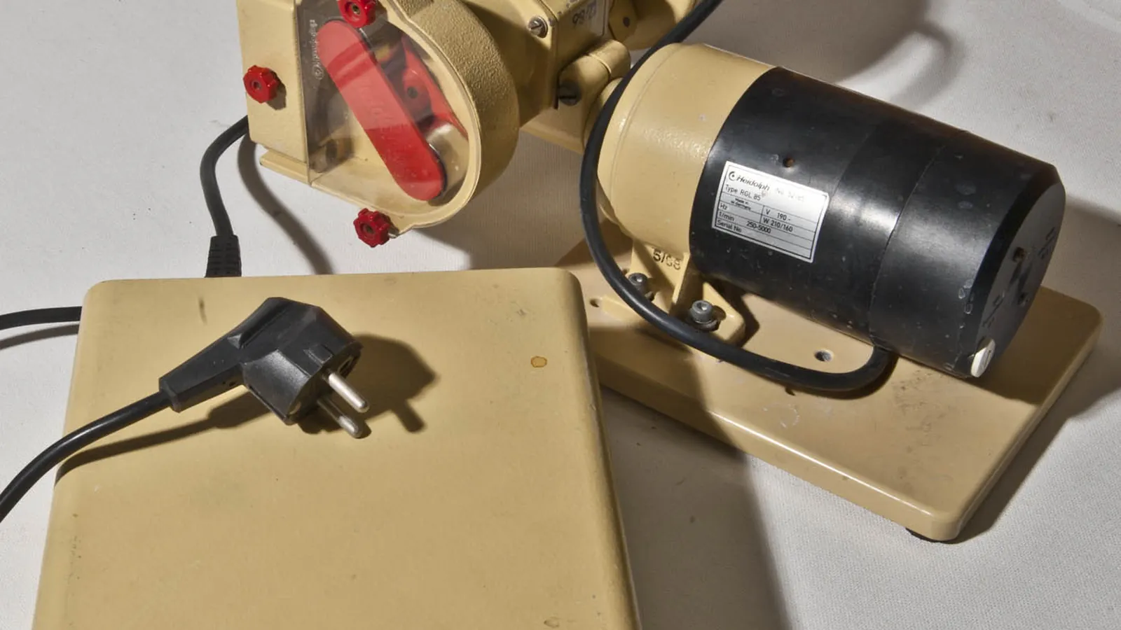 Benchtop peristaltic (tubing) pump with red rollers