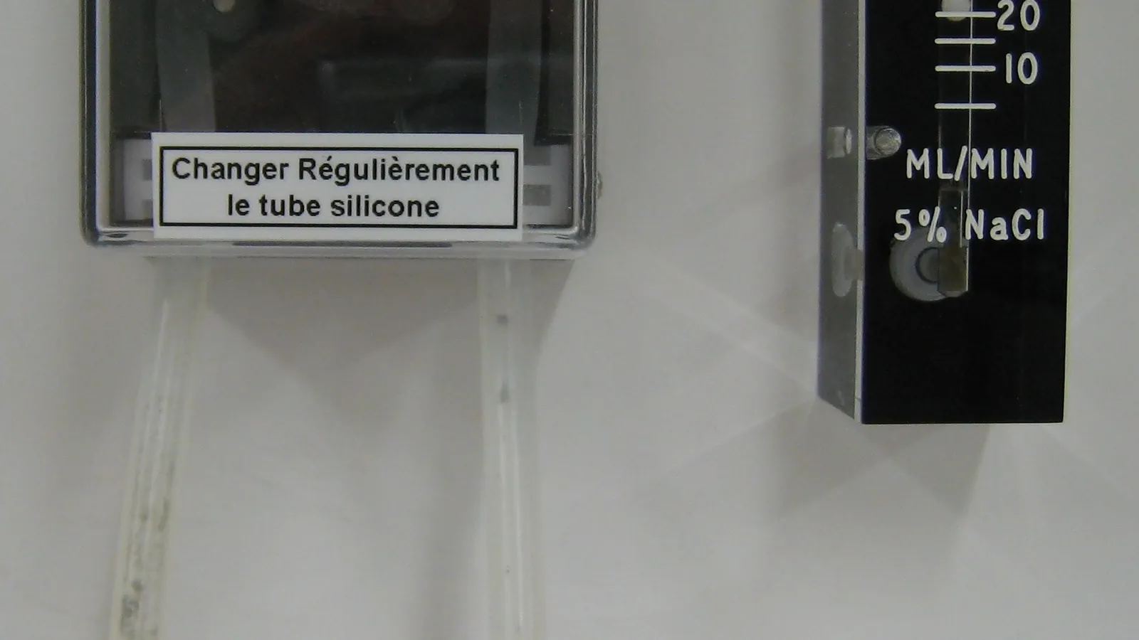 Wall-mounted peristaltic dosing pump with flow meter and silicone tubing